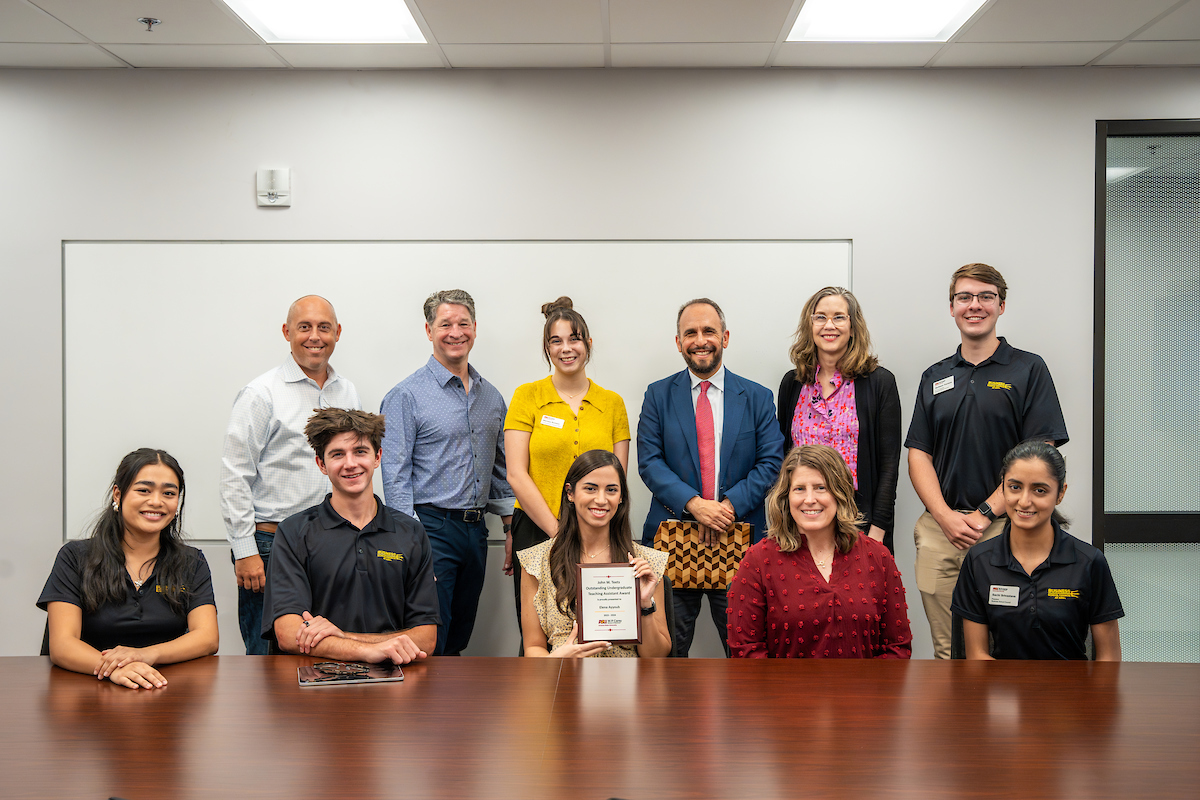 Elena Ayyoub is presented with a John W. Teets Outstanding Teaching Award