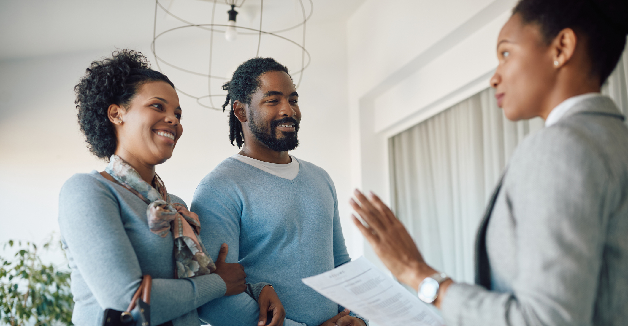 A couple talks to a realtor