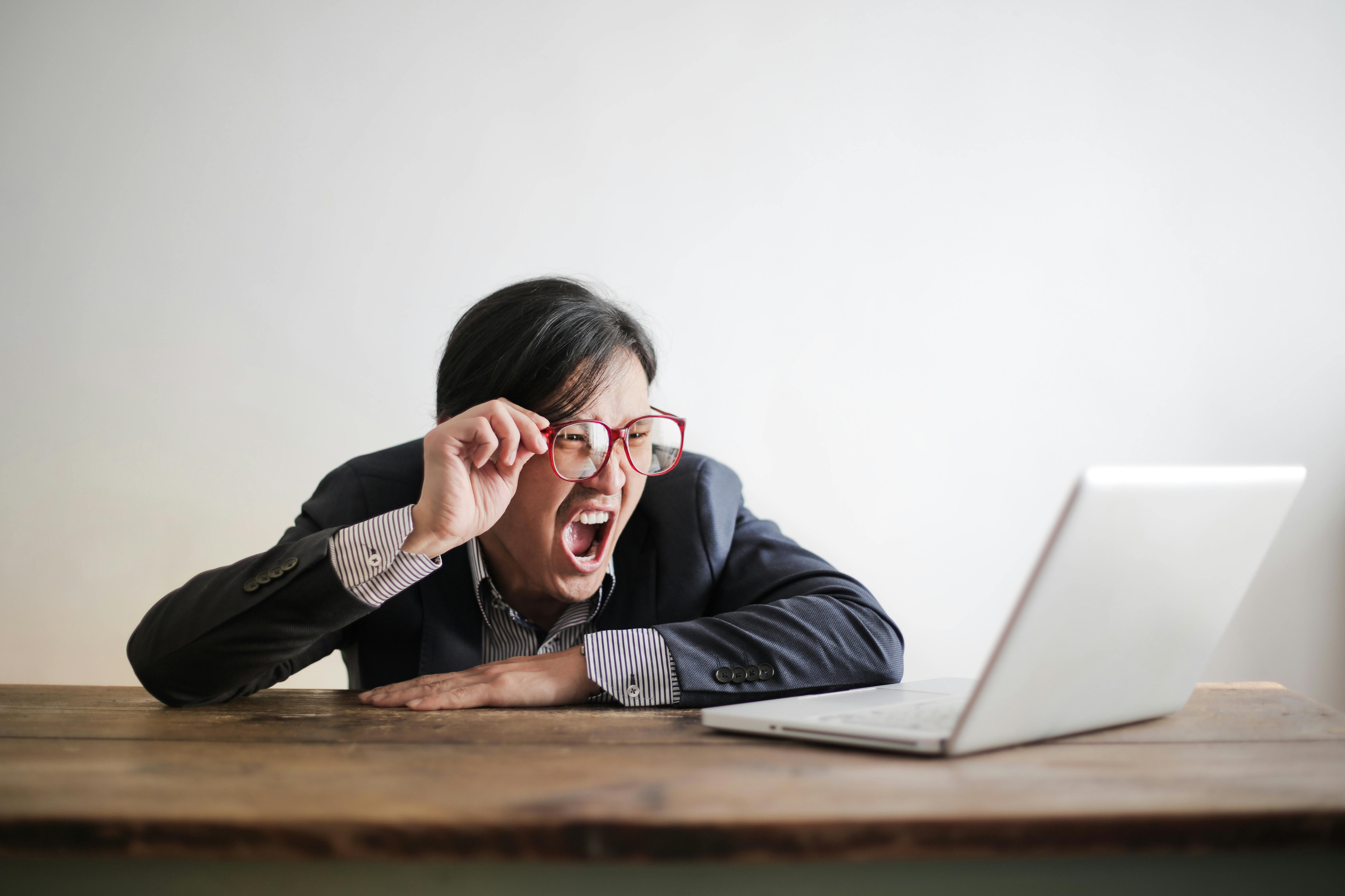A woman yelling at a laptop.