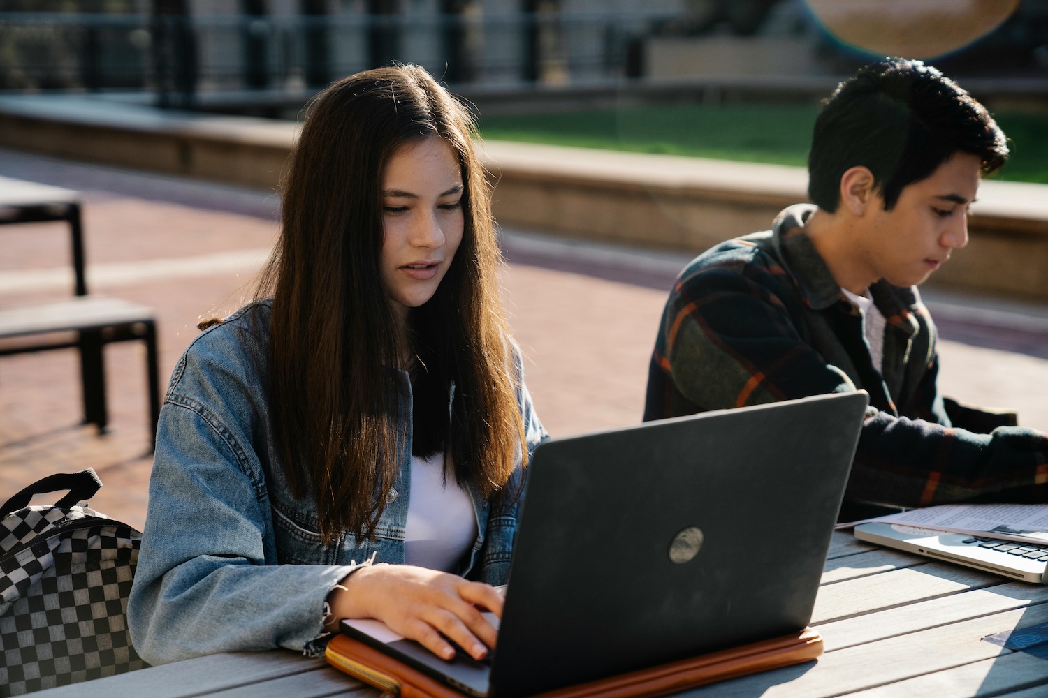 a woman and man student studying at school next to each other